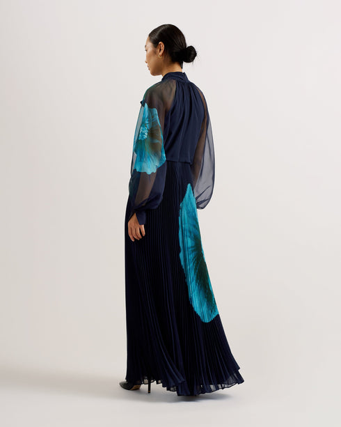MANAMI-Dresses-The MANAMI maxi dress exudes glamour from head to toe, starting with a classic bow tie around the neck and ending with a fine pleated skirt. Floral details are printed on this piece to add an understated splash of colour, finished out with sheer bishop sleeves and a full hem to create plenty of swish. Maxi dress Large scale floral print details High neck with pussybow tie Sheer long bishop sleeves Pleated A-line skirt Front split Concealed zip fastening Chae is 5'9.5" / 1.77m and wears a Ted
